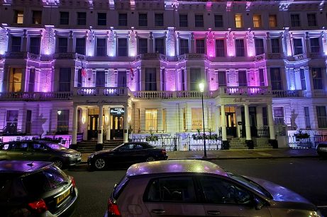 Front of hotel by night in London city.